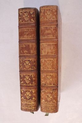 deux vieux livres posés l'un sur l'autre sur une table
