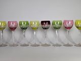 six verres à vin sont alignés sur une surface blanche