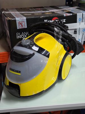 a yellow and gray steam cleaner on a white table