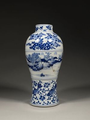 blue and white porcelain vase with a landscape scene on it