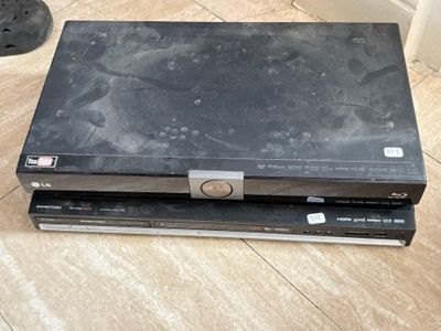 two dvd ' s sitting on top of each other on the floor