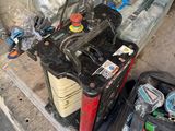 an image of a car battery and tools in a garage