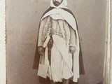 an old photo of a man in a turban and shawl