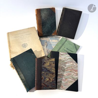 several old books sitting on top of each other on a table