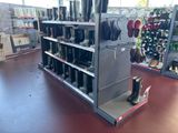 a rack with boots and boots on it in a store