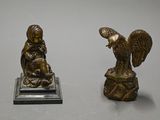 pair of antique bronze figurines of a woman and an eagle on a rock