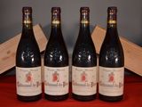 three bottles of red wine sit on a red cloth next to a wooden box