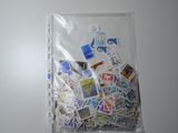 a bag full of stamps on a white surface