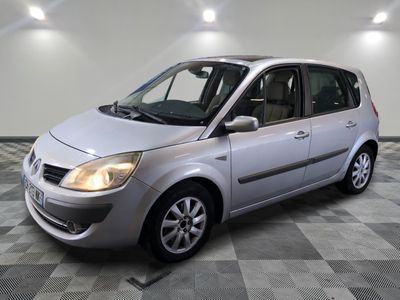 a picture of a small silver car parked in a garage