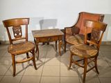 three wooden chairs and a table on a tiled floor