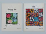 two prints of flowers are on display on a wall