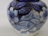 a blue and white vase with blue flowers on it