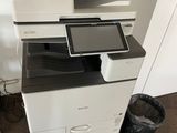 a printer that is sitting on top of a pile of papers