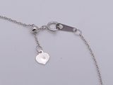 a close up of a chain with a heart charm on it