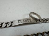a silver bracelet with a name on it and a ring on it