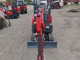 an image of a small red tractor parked in a lot