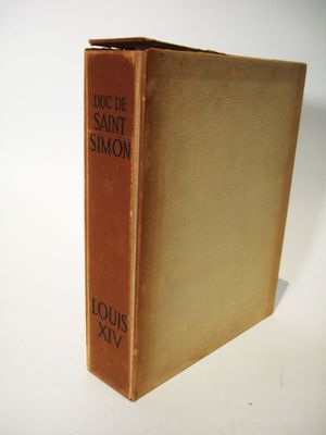 an old book sitting on top of a white table next to a white wall