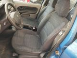 a blue car with a black seat cover and a steering wheel
