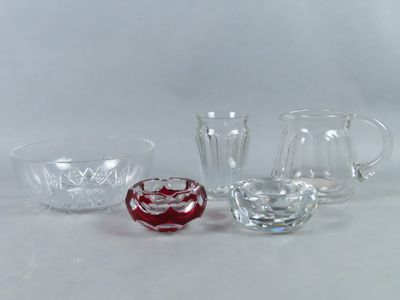 three glass pitchers and a pitcher on a white surface