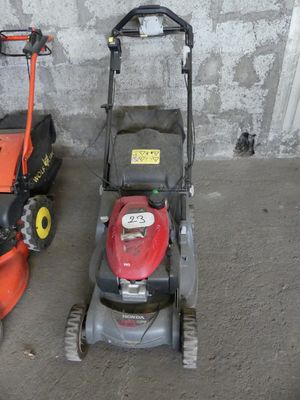 two lawn mowers that are sitting next to each other