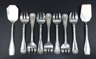 a lot of forks and spoons on a black table