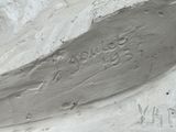 a close up of a sculpture of a boat on a beach