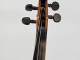 a close up of a violin on a stand with a white background