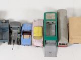 several toy cars are lined up in a row on a white surface