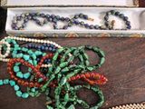 a box with a bunch of beads on it on a table