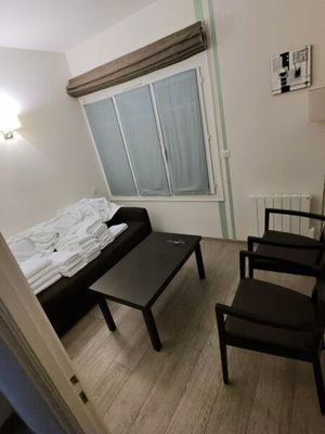 a small living room with a couch and a coffee table
