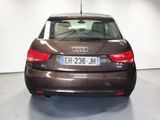 the back of a brown audi car parked in a garage