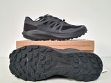 a pair of black hiking shoes sitting on top of a box