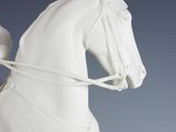 a white statue of a woman riding a horse