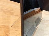 a mirror that is on a table with a laptop