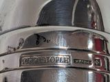 a close up of a silver object with a name on it