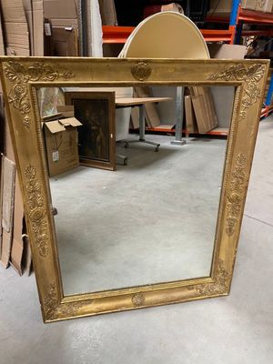 a mirror that is sitting on the floor in a room