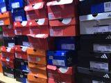boxes of shoes are stacked on a shelf in a store
