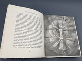 an open book with a drawing of a clock on it