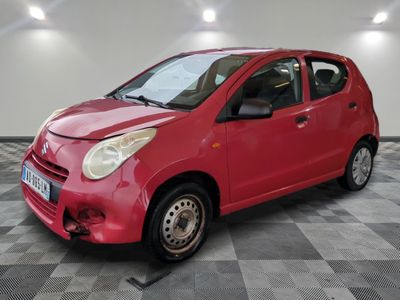 a picture of a small red car parked in a garage