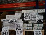 a lot of boxes with price tags on them in a store