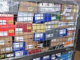 a metal cage filled with boxes and boxes of assorted items