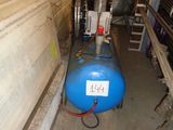 a blue tank sitting next to a blue machine in a room
