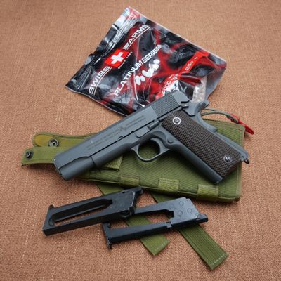 a gun that is laying on the ground next to some other items