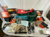 a table with a bag, camera and other items on it