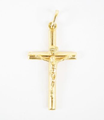 a yellow gold cross pendant with a crucifix on a white background