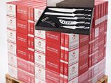a stack of red boxes with a knife on top of it