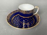 a close up of a cup and saucer on a table
