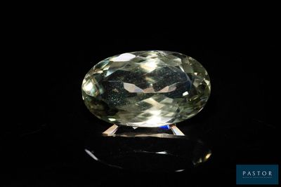 a yellow sapphire stone on a black surface