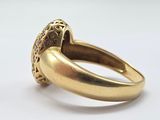 a close up of a gold ring with a diamond in the center
