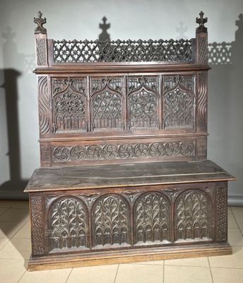 a wooden bench with carvings on it in a room